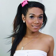 Long haired ladyboy in pink top stripping